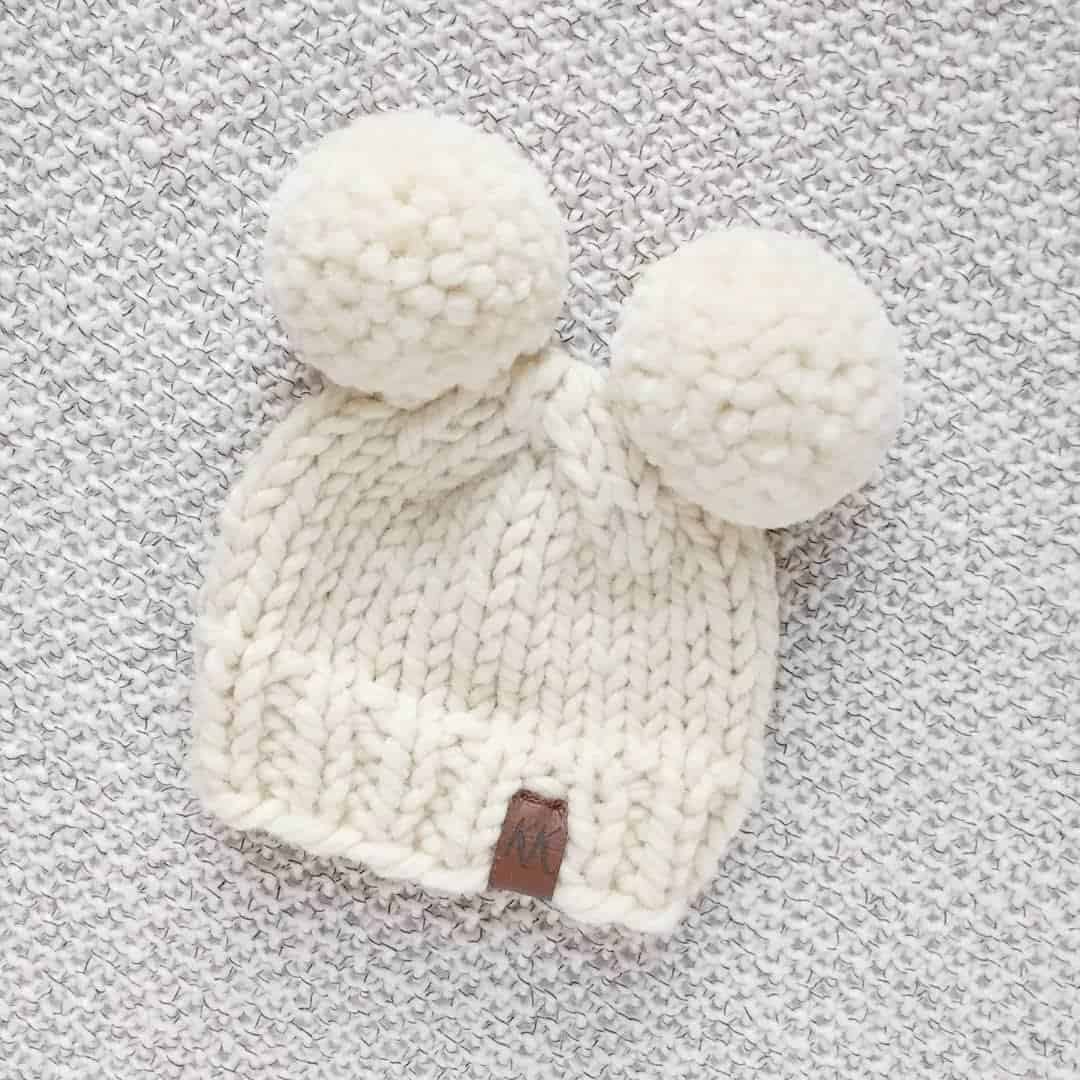 baby hat with two pom poms